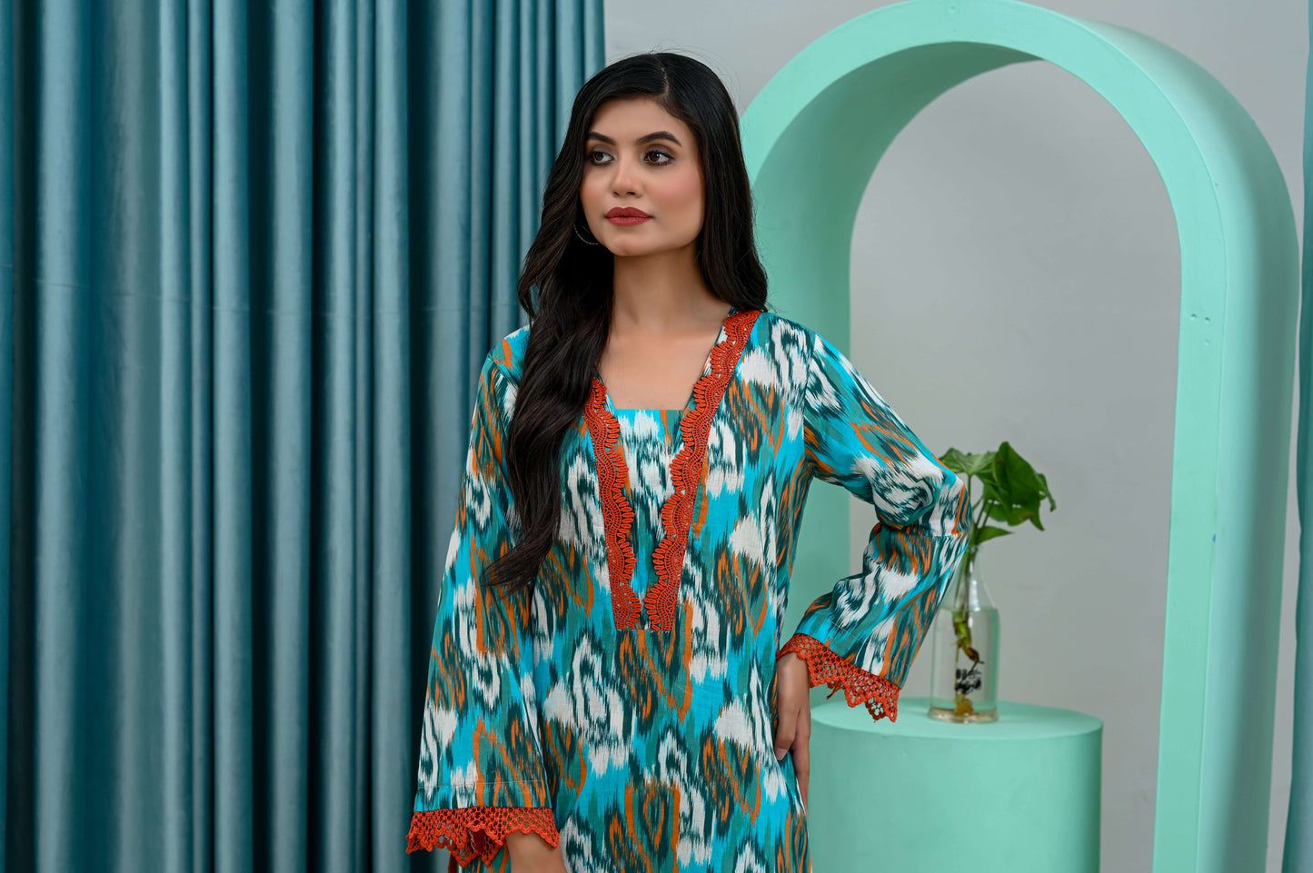 Model showcasing a vibrant 2-piece multi printed lawn suit, featuring colorful patterns and elegant detailing.